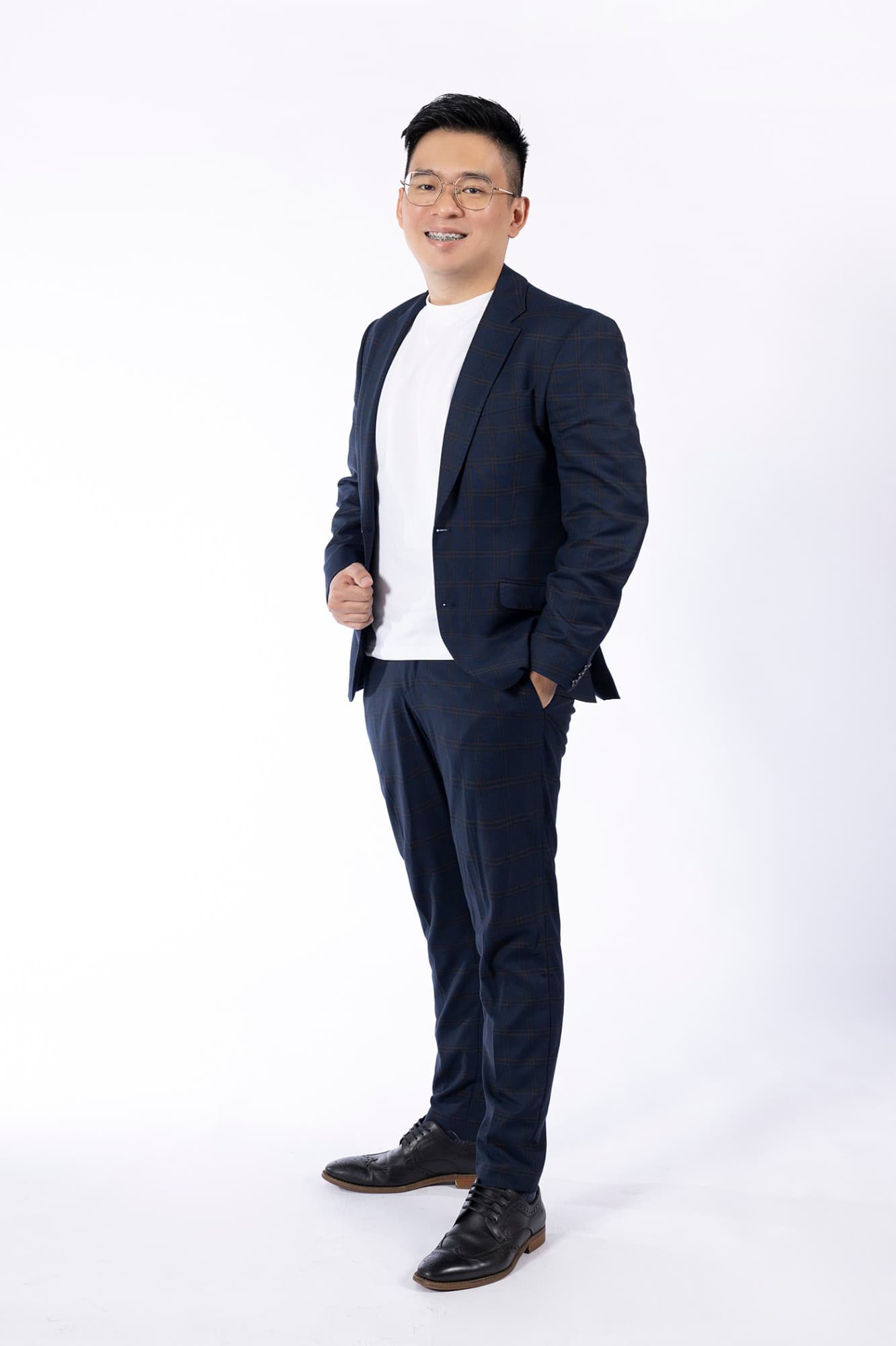 Jaxon Ng in a navy suit, smiling